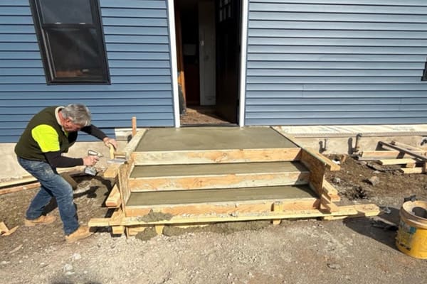 A Green Rhino Builders employee replacing a deck at a customer’s home